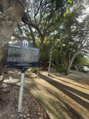 A historic signboard titled 'Historic Lemon Avenue' with a detailed description of the area's history. - Elegant Hotel Room steps from Ocean Street Parking (Miami)