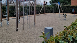A playground with various equipment such as swings and climbing structures. - semi-detached house with pool 3 bedrooms near the beach (Platja d'Aro)