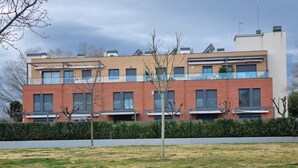 A modern multi-story residential building with a brick facade, large windows, and a flat roof. - semi-detached house with pool 3 bedrooms near the beach (Platja d'Aro)
