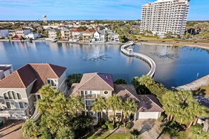 Stunning coastal views of a tranquil residential area with a picturesque fountain and lush green surroundings.