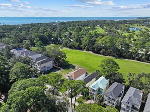 Un quartier résidentiel avec des maisons, un terrain de golf et une vue sur l’océan.