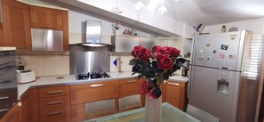 Fridge, stovetop, dishwasher, coffee/tea maker