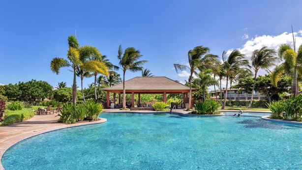 A clear blue pool with a gazebo in the center, surrounded by palm trees and greenery. - Includes Mauna Lani Beach Pass.  101 Kulalani (Mauna Lani Resort)