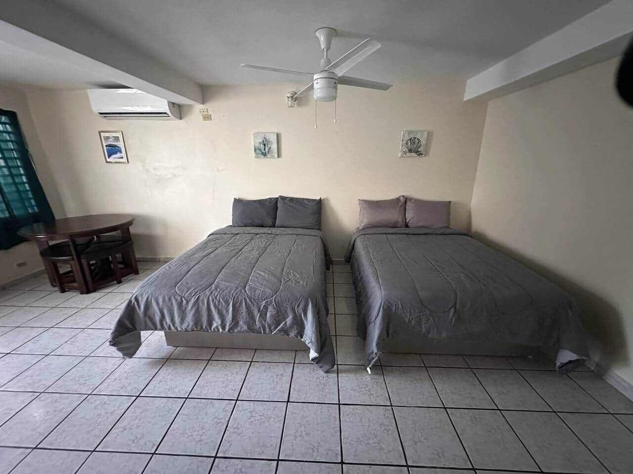 Spacious room with two full beds and place for dinner.