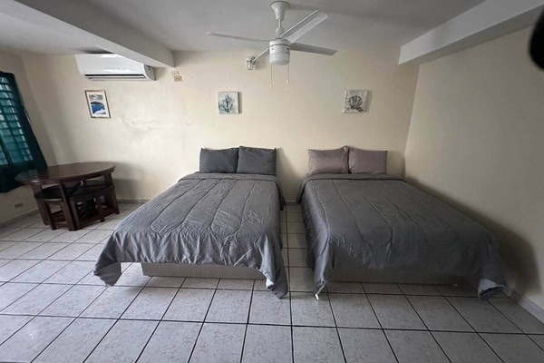Spacious room with two full beds and place for dinner.