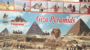A panoramic view of the Giza Pyramids with multiple people and camels. - City inn hotel  (Cairo)