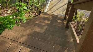 A wooden staircase leading to a dock over water, surrounded by trees. - Beautiful waterfront lodge, private dock and breath taking views of Smith Mt. (Pittsville)