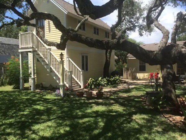 Stunning two-story home with a grand staircase and beautifully manicured lawn.