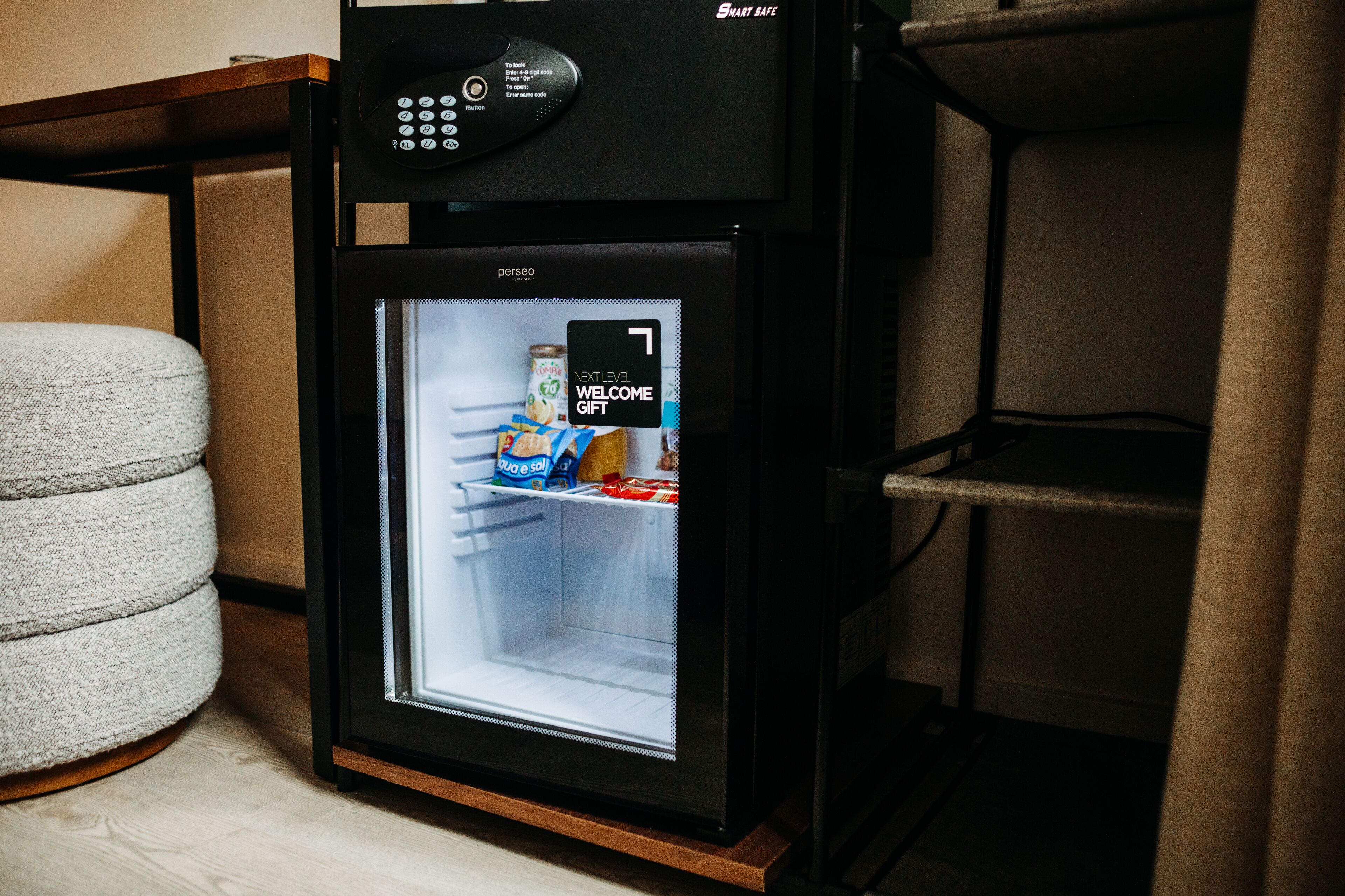 A black refrigerator with a digital display and a small screen showing a welcome message.