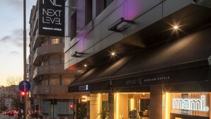 A modern hotel building with a prominent 'NL NEXT LEVEL PREMIUM HOTELS' sign. - Next Level Premium Hotels (Lisbon)