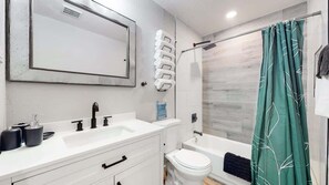 Bathtub, eco-friendly toiletries, hair dryer, towels