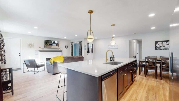 A modern kitchen with a central island, built-in appliances, and pendant lighting. - Spacious Family Retreat in Denver (Denver)