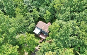 An aerial view of a house surrounded by dense green trees. - Cabin near River, Firepit, Family-friendly, WiFi, Great Location, Veteran owned! (Rileyville)