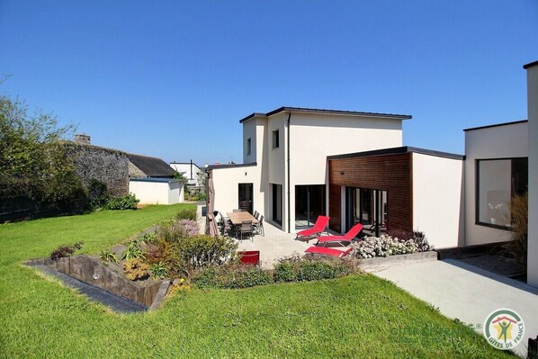 Relax in a serene outdoor space with a well-maintained lawn and garden, perfect for unwinding in the fresh air.