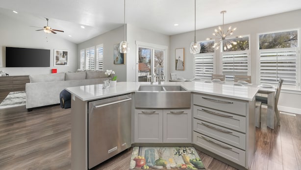 A modern kitchen with a central island, stainless steel appliances, and pendant lighting. - Family Oasis Getaway (Lehi)