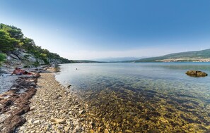 Surrounded by serene lakeside tranquility, this peaceful haven offers breathtaking views of the surrounding hills and clear waters.