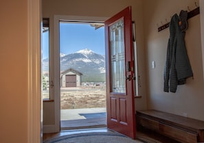 Enter a mountain retreat with a view of snow-capped peaks from the garage.