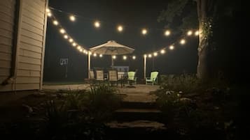 Enjoy dining or socializing under the stars on this serene patio surrounded by lush vegetation.