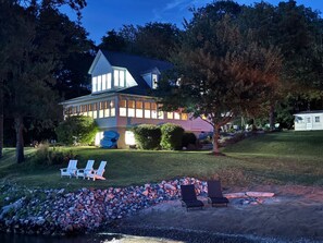 A large house with a well-maintained lawn, outdoor seating area, and a swimming pool. - 4 King Bed Private Beach +Pet Friendly +Pickleball (Sterling)
