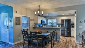 A modern kitchen with a dining area, featuring a large island, stainless steel appliances, and a chandelier. - Waterfront Sleeps 6 w/private boat dock and heated pool. (Crystal River)