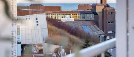 A modern building with a glass facade and a sign that reads "FISHER CENTER."