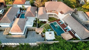 A modern resort with multiple villas, a central pool, and lush landscaping. - Luxurious 4BR Villa with Pool, Bali Villa 2206 (Bali)