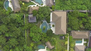 An aerial view of a resort with multiple swimming pools, lush greenery, and a variety of building structures. - Great 2BR Villa W/ Amazing Pool & Garden, Bali Villa 2226 (Bali)