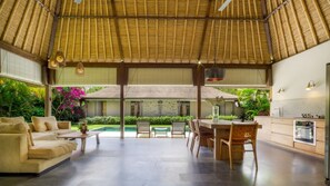 A spacious indoor area with a high ceiling, a pool, outdoor seating, and a kitchen area. - Great 2BR Villa W/ Amazing Pool & Garden, Bali Villa 2226 (Bali)