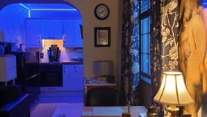 A compact living space with a kitchen, a dining area, and a living room.