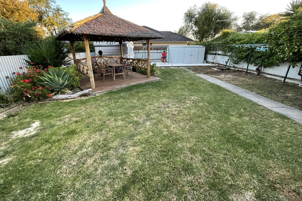 Large backyard with outdoor seating and BBQ!
