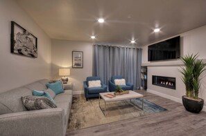 Cozy living space with a fireplace, comfortable seating, and a large window.