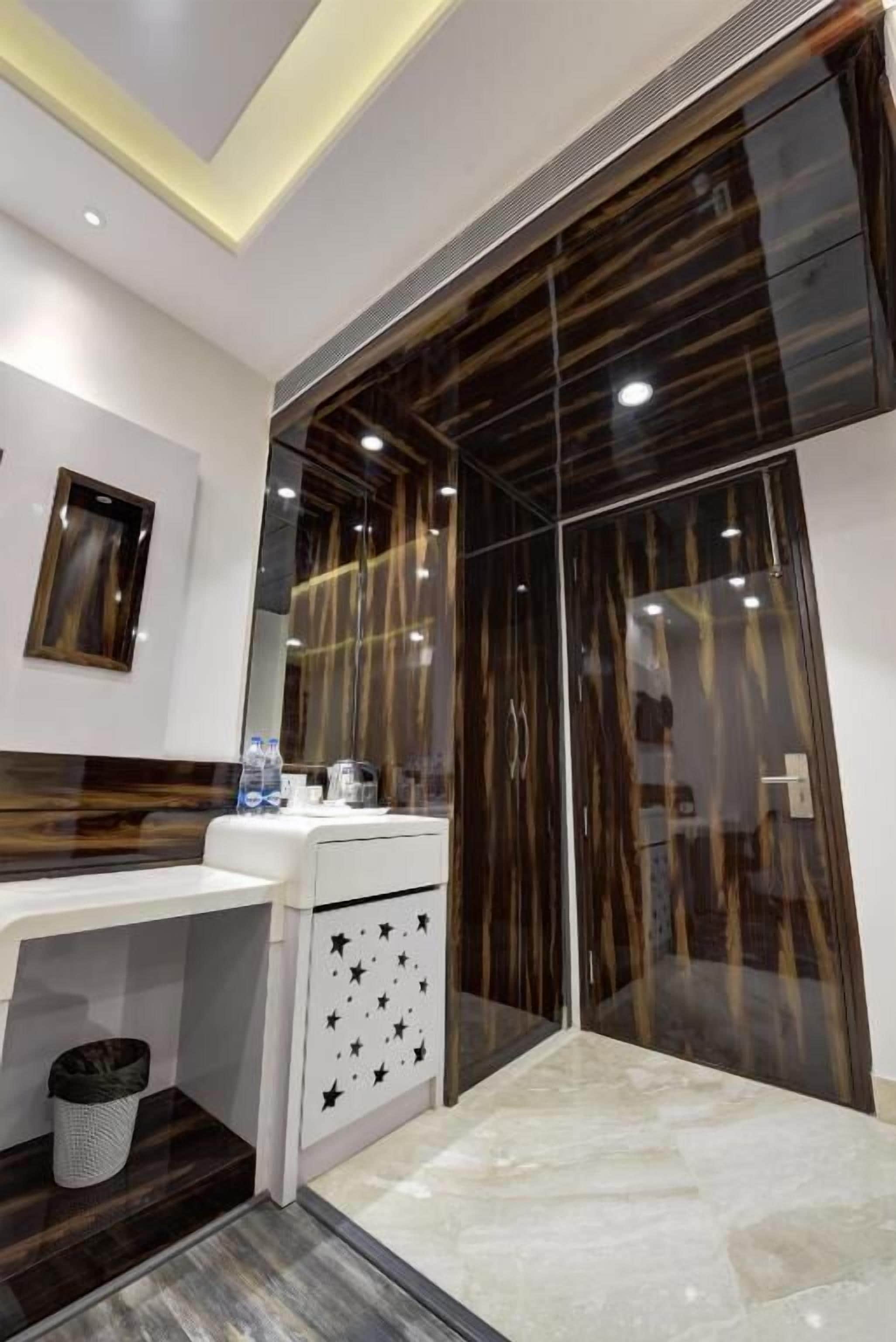 A modern bathroom with a vanity, a mirror, and a cabinet with star decorations.