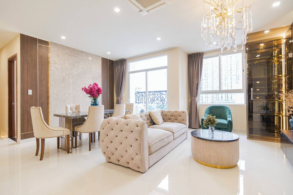 A modern living room with a sofa, dining table, chairs, and a coffee table.