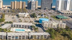A coastal cityscape with high-rise buildings, a parking lot, and a swimming pool. - 2 Blocks from the Beach and Ocean! Updated 2 bedroom Condo with Pool! Our Place at the Beach #H107 (Ocean City)
