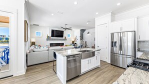 A modern kitchen with white cabinets, stainless steel appliances, and a marble countertop. - *SPECIAL* Summer Salt 38*NEW* SLEEPS 19 4 bed 4.5 bath home Orange Beach (Orange Beach)