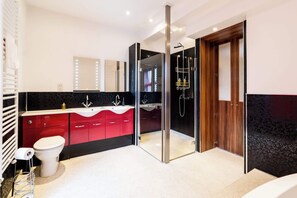 Bathtub, hair dryer, towels, shampoo