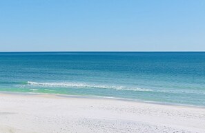 A beach with a clear sky and calm sea. - HeartWind Cottage -Quaint and cozy with private pool, steps to the beach (Santa Rosa Beach)