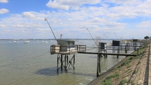 A waterfront property with elevated wooden structures, possibly for fishing or viewing. - Charme de Villès Martin by Interhome (Saint Nazaire)