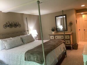 A bedroom with a four-poster bed, a dresser, a mirror, and a wall-mounted bicycle rack. - Lovely Mountain Villa-Close to Amenities-Walk to Fairfield Lk (Sapphire)