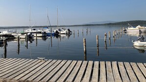A wooden dock with boats moored at the end.