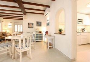 Cozy living space with a dining area, seating area, and fully equipped kitchen.