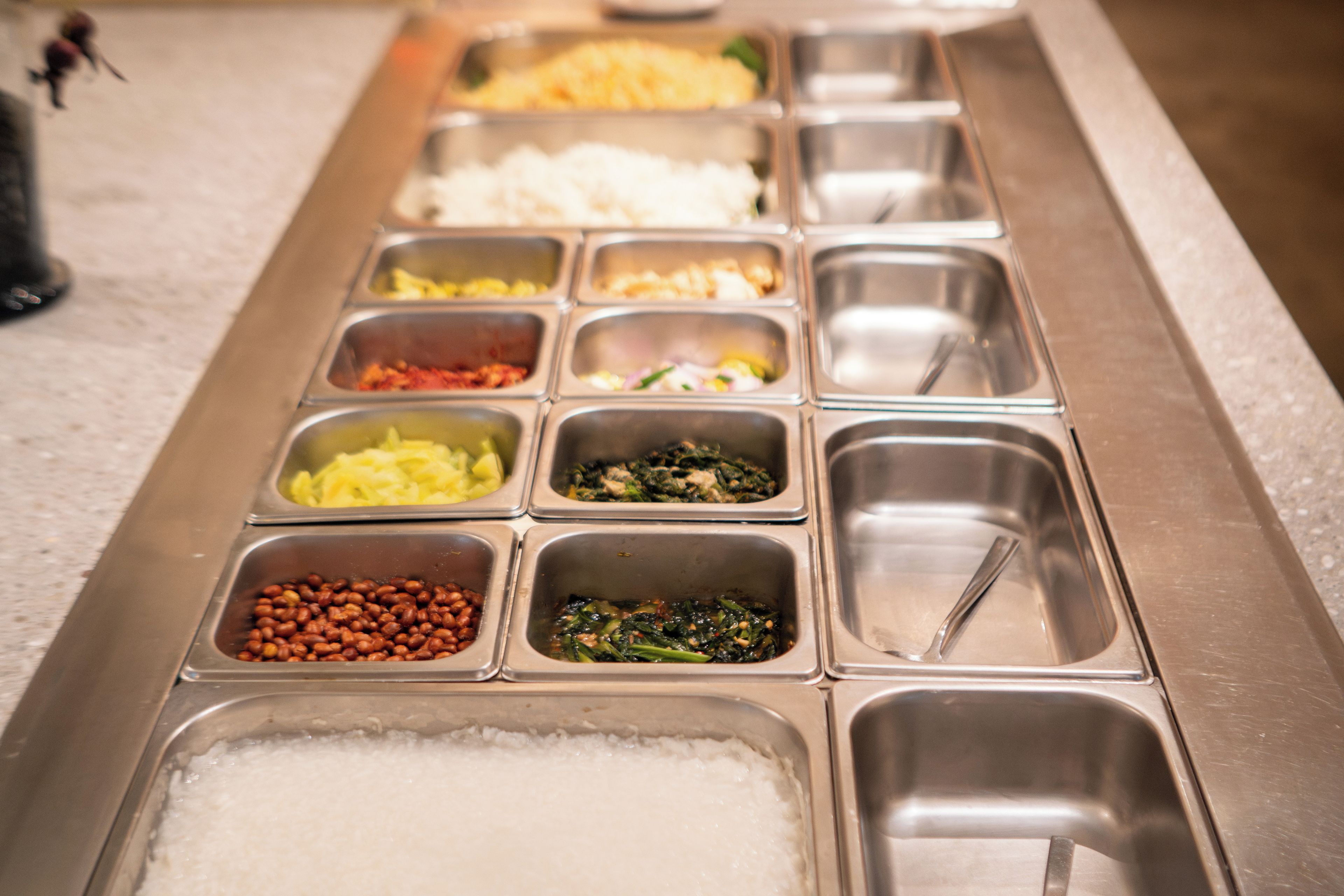 A buffet line with various food options.
