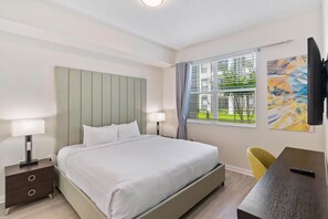 Urban Elegance: Unwind in style in our bedroom, where modern design meets convenience with a sleek Smart TV for a sophisticated stay. - 3BR Condo w/ Resort Access near OCC, Theme Parks (Orlando)