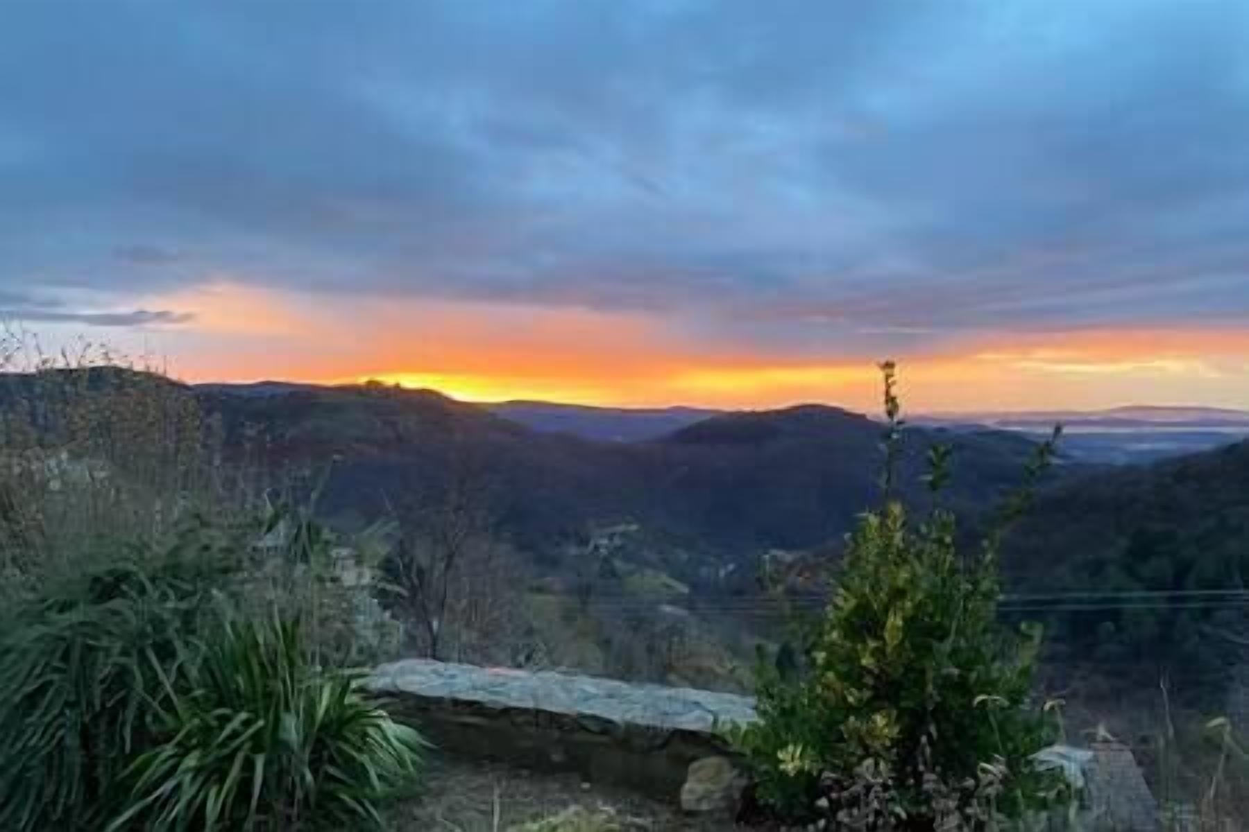 A mountainous landscape with a sunset.