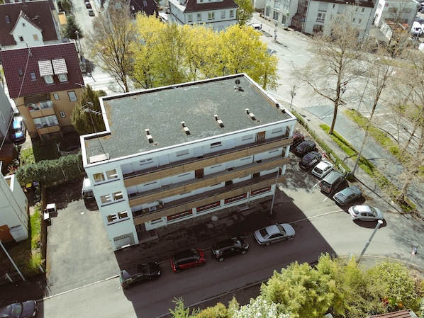 A multi-story parking garage with several cars parked on the ground level.