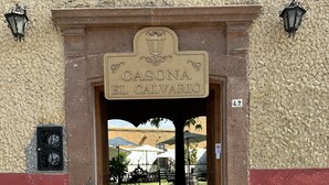 The entrance to a building with a sign reading "CASONA EL CALVARIO".