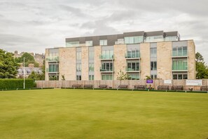 A modern building with multiple windows and a flat roof. - Square Green (No 16) | With Balcony (St Andrews)