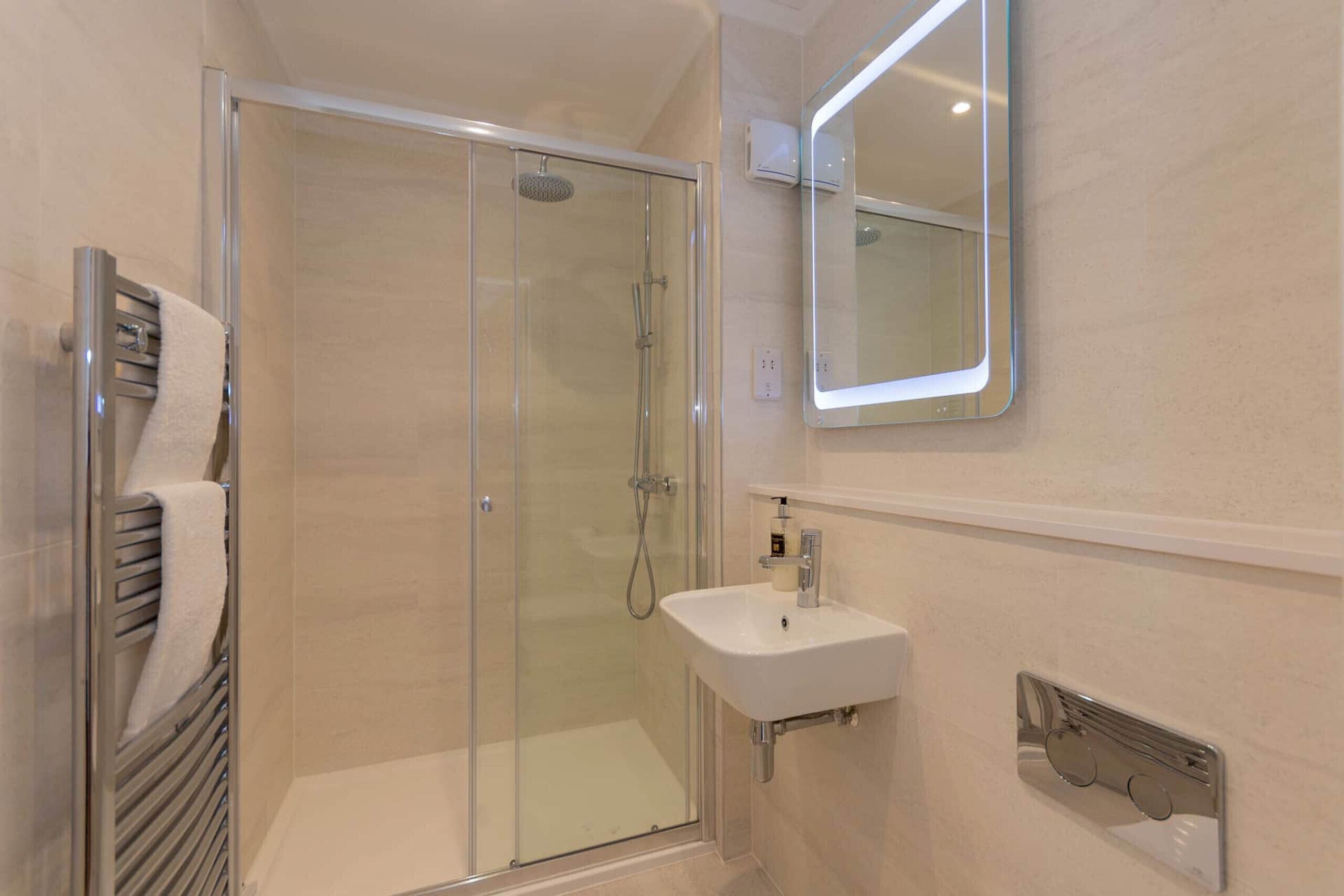 Shower, hair dryer, towels, toilet paper