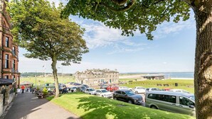 A parking area with cars and a building in the background. - Gillespie Apartments | Spectacular Penthouse (St Andrews)