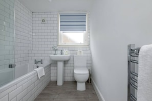 Bathtub, hair dryer, towels, soap